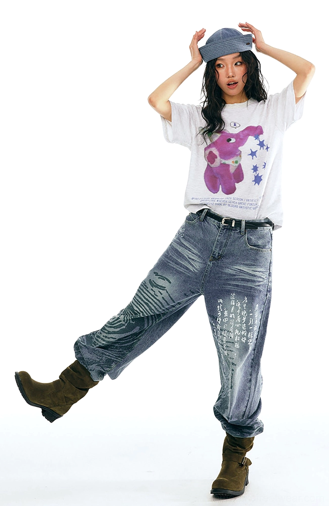 Low front view of Chinese calligraphy and water ripple print straight-leg jeans styled with graphic tee and ankle boots