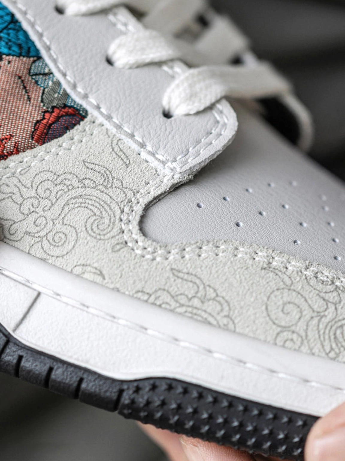 White Chinese embroidered bird brocade court sneakers showcasing colorful embroidered textile panels and low-top streetwear profile