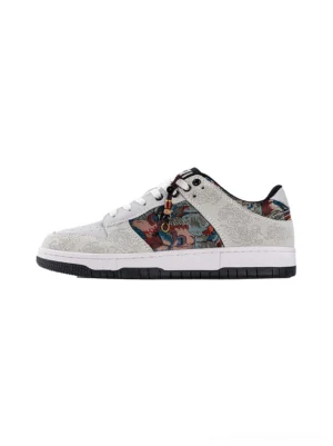 White Chinese embroidered bird brocade streetwear court sneakers shown in side profile with colorful textile panels and black rubber outsole
