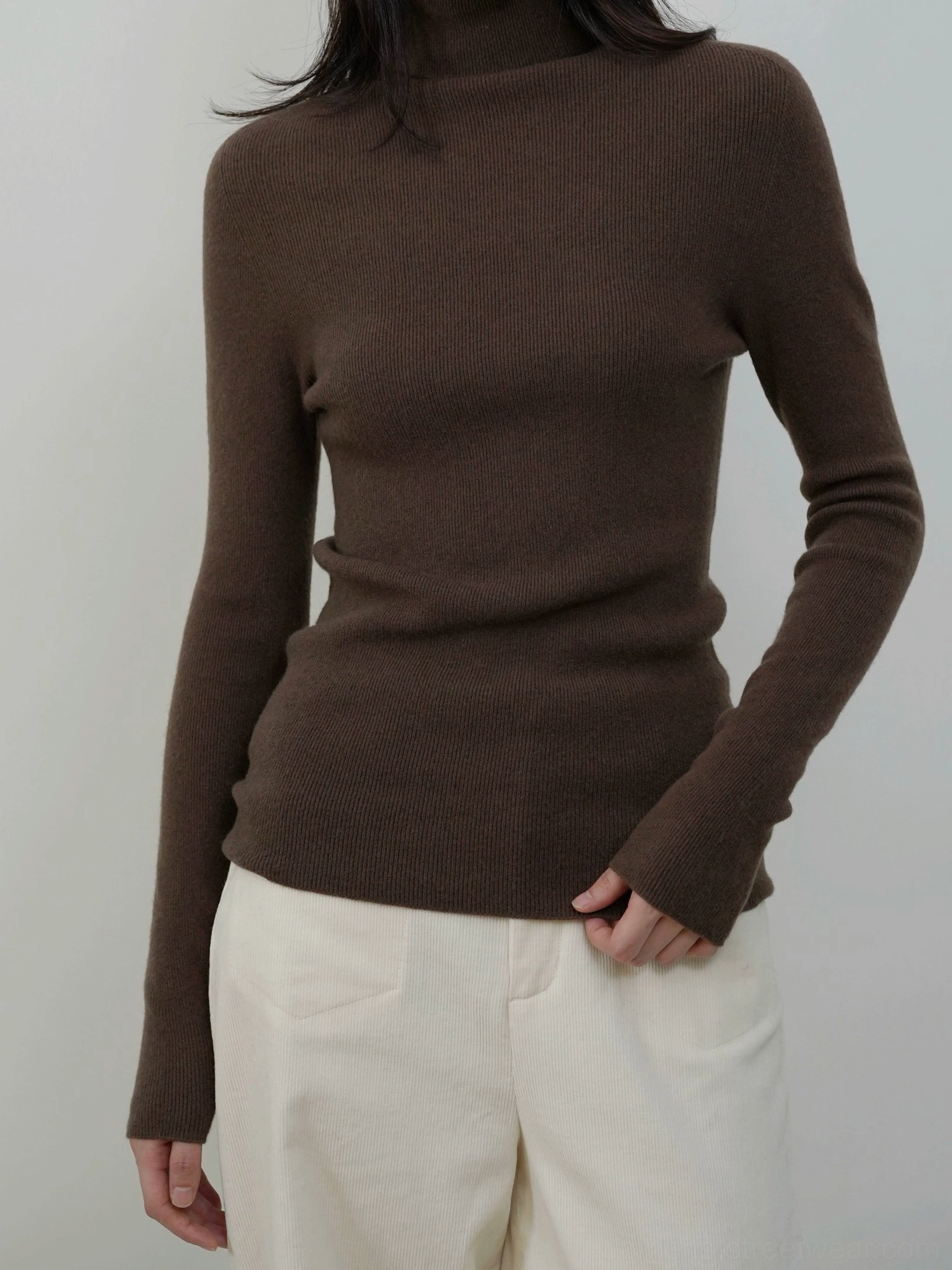 Dark chocolate brown slim fit mock neck knit sweater styled with off white casual trousers