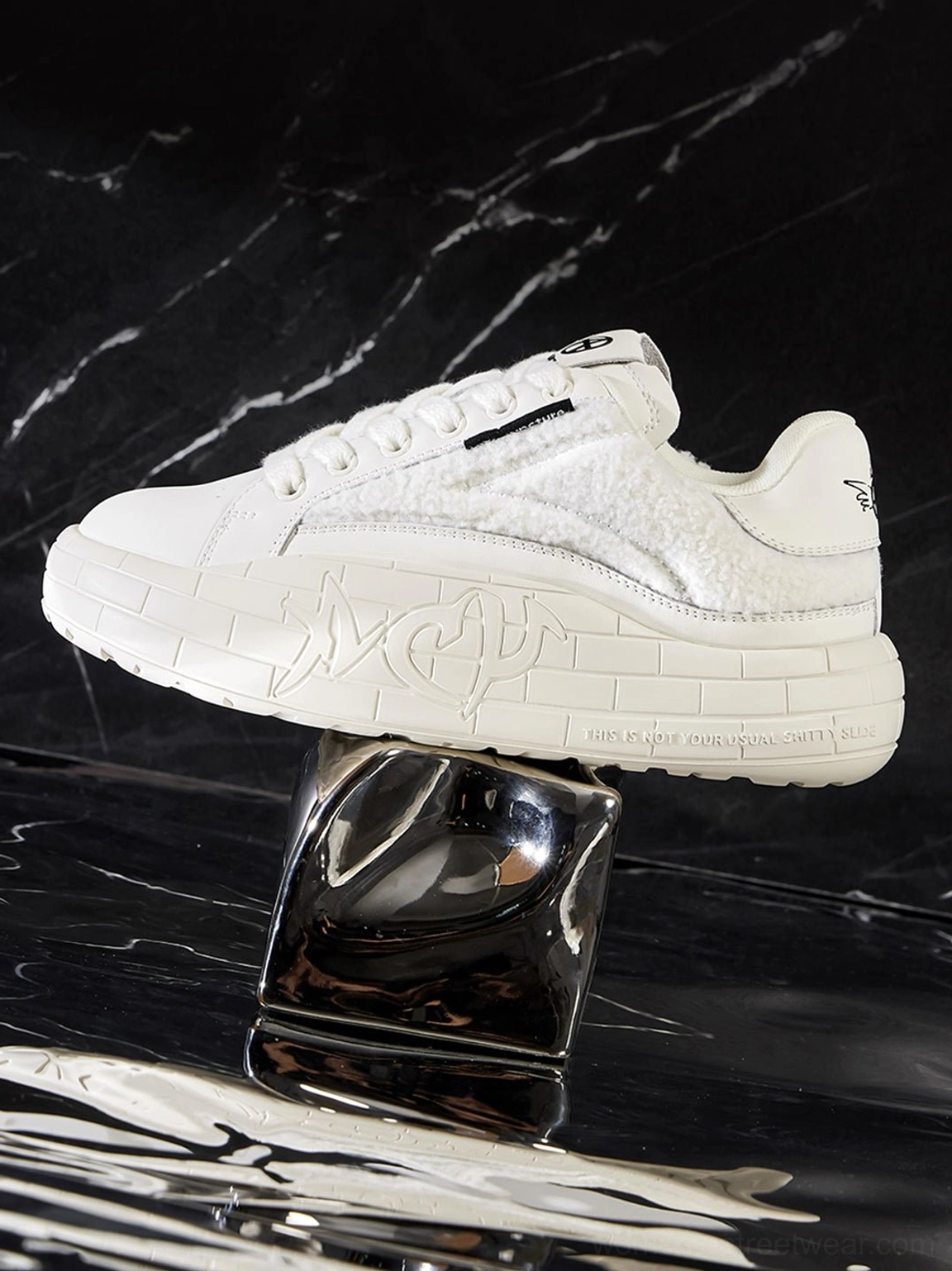 Chunky black fleece sneakers with sculpted platform soles for modern Y2K casual outfits
