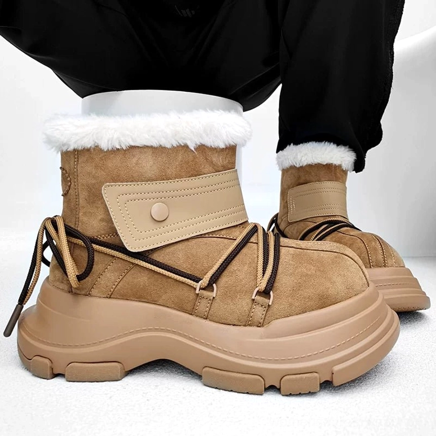 Close front three-quarter view of chestnut chunky platform shearling snow boots with brown hiking laces and wide strap