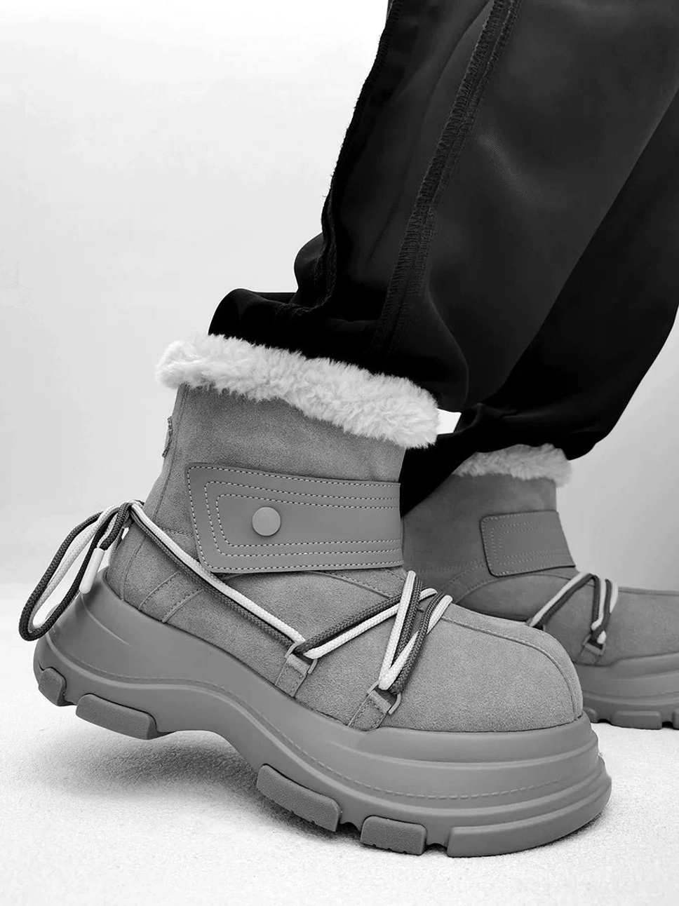 Gray chunky platform shearling snow boot with white faux fur trim, contrast hiking laces, and rugged rubber outsole