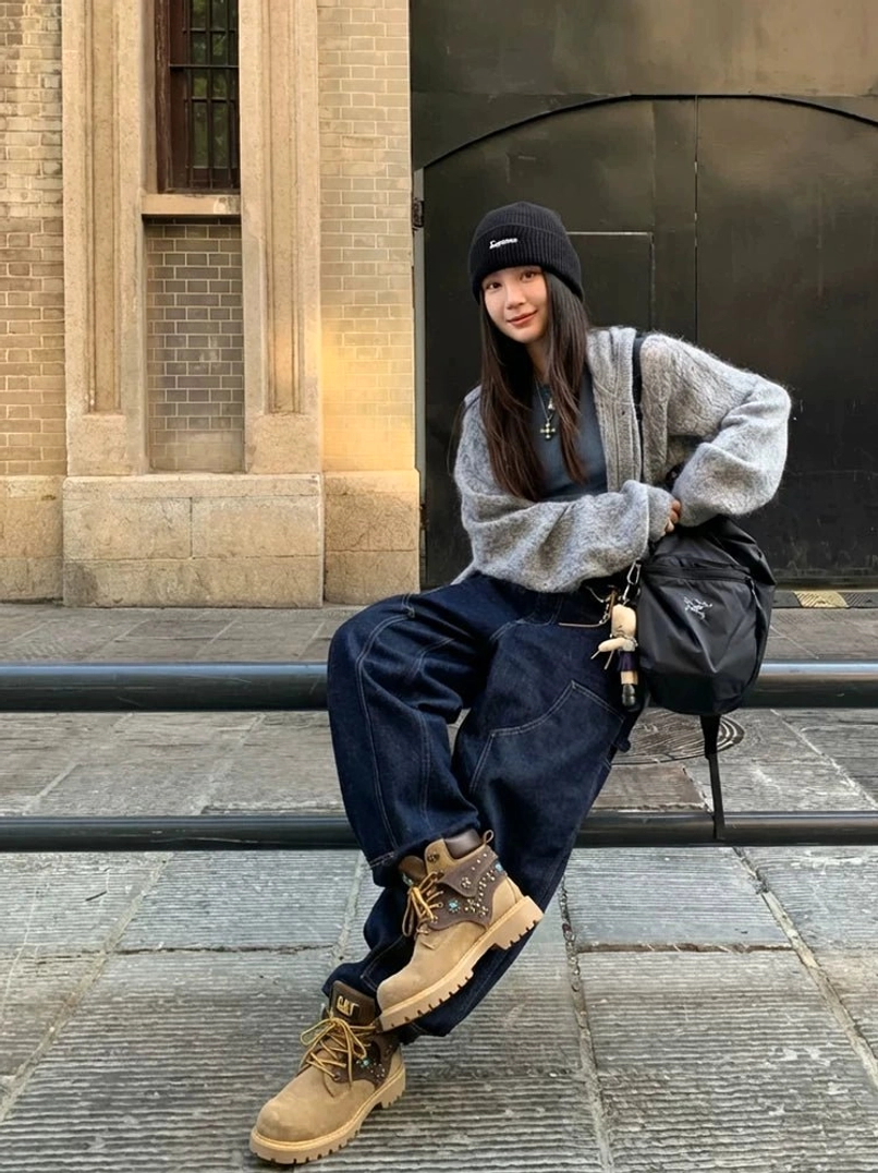 Chunky turquoise detail western ankle boots paired with wide-leg denim pants, cropped sweater and black beanie