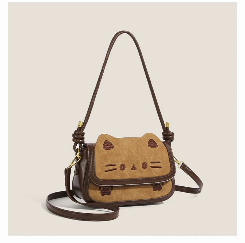 Khaki cinnamon kitty convertible shoulder bag in caramel brown PU with embroidered cat face and gold tone hardware front three quarter view