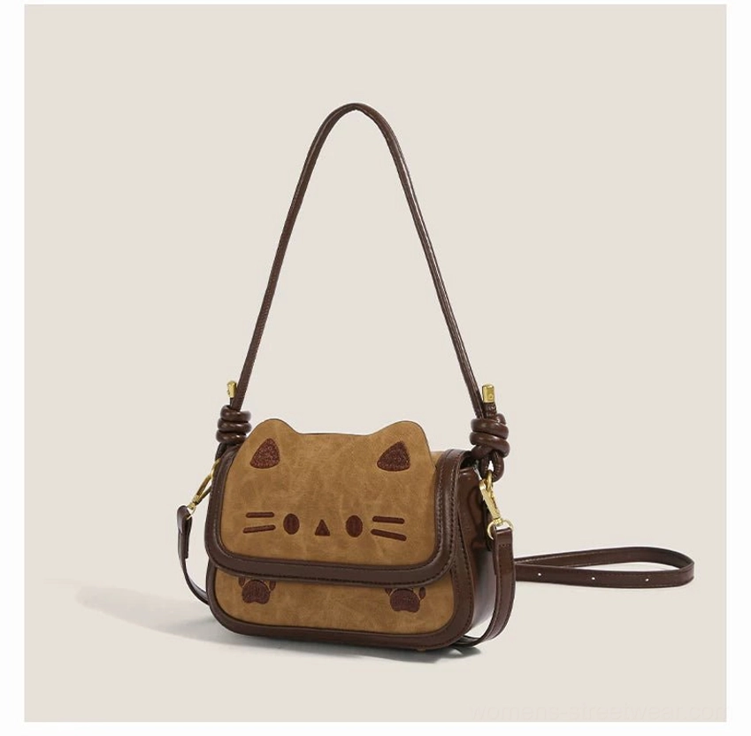 Khaki cat face shoulder crossbody bag showing dark brown contrast trim adjustable long strap and gold tone buckle hardware