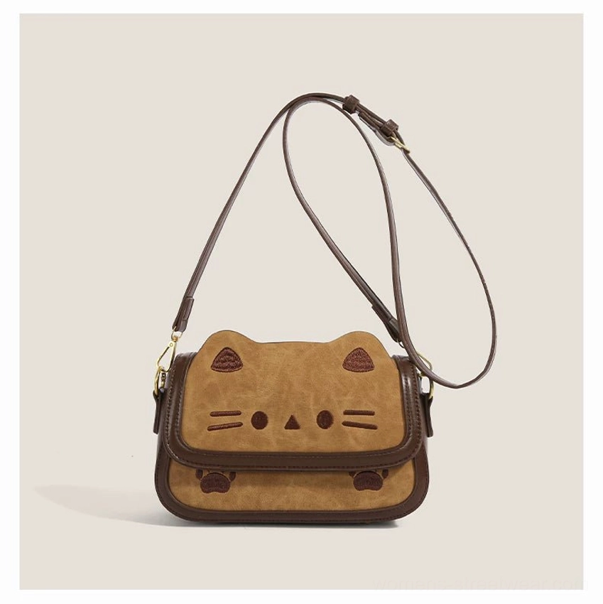 Full front flat view of khaki cinnamon cat shoulder bag with cute embroidered feline face and natural hanging strap
