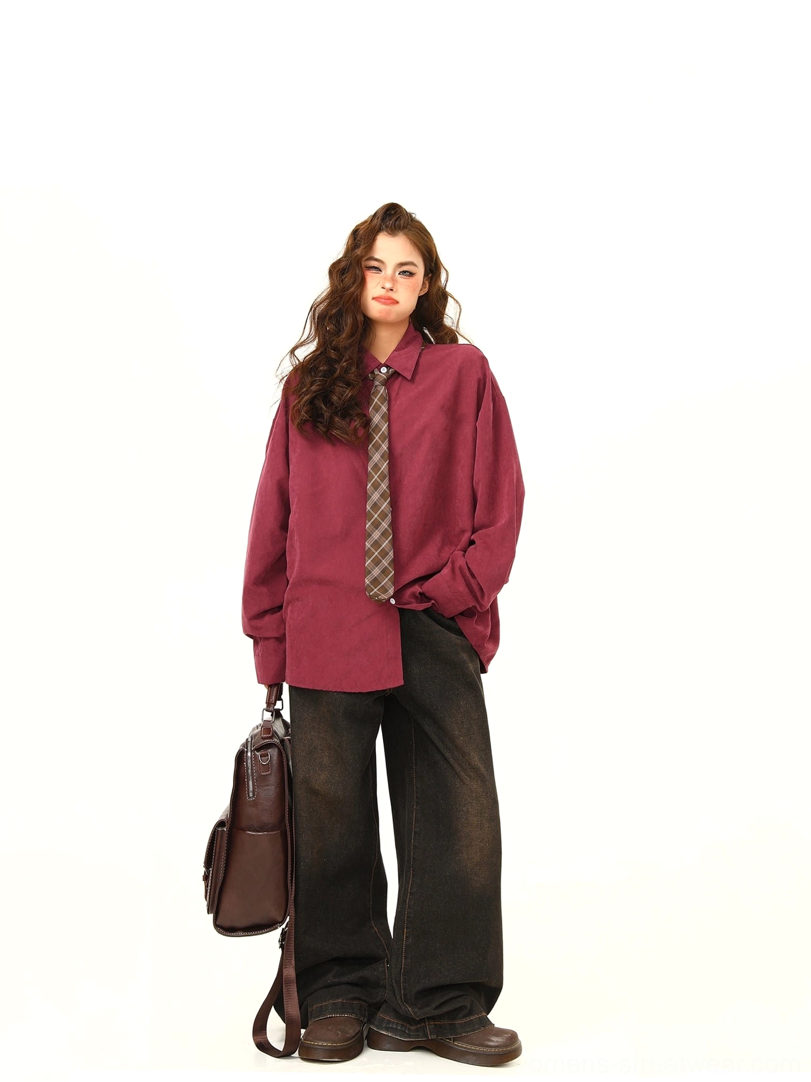 Full front view of claret oversized corduroy shirt with plaid matching tie, relaxed drop shoulders, white buttons, and black wide-leg jeans