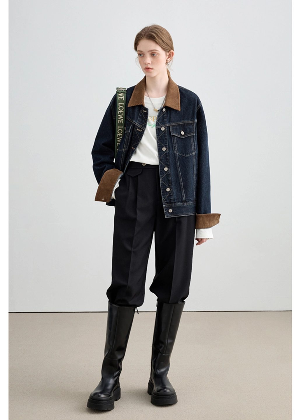 Classic denim trucker jacket with warm corduroy accents and visible geometric detailing around the button placket