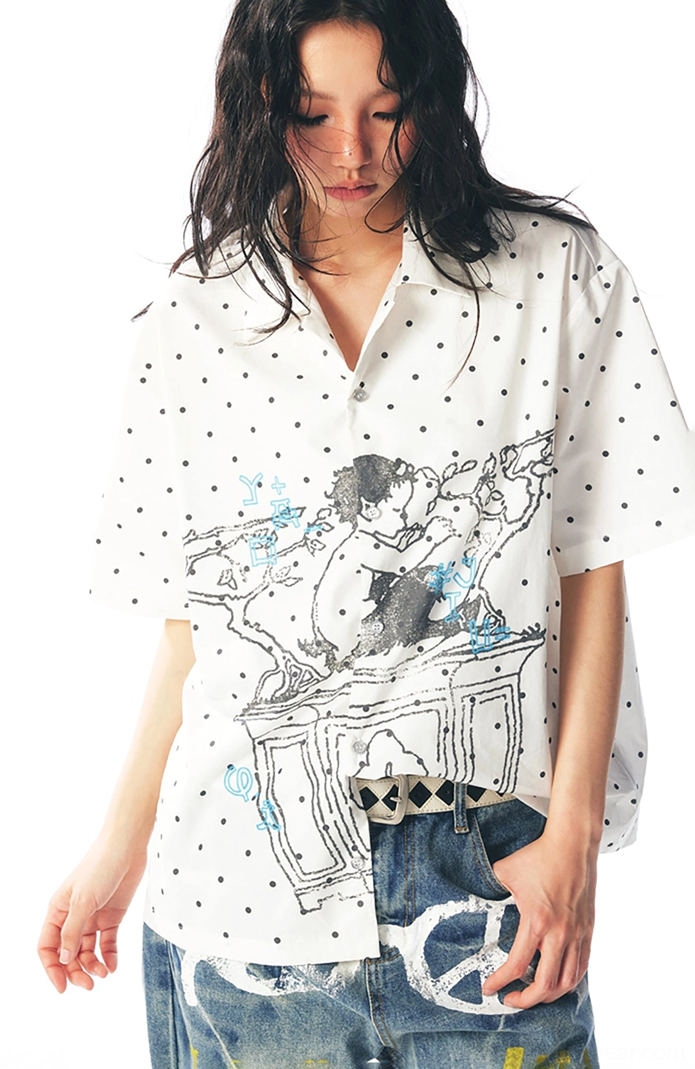 Close-up of lightweight cotton polka dot fabric and detailed cartoon artwork on a graphic short sleeve shirt