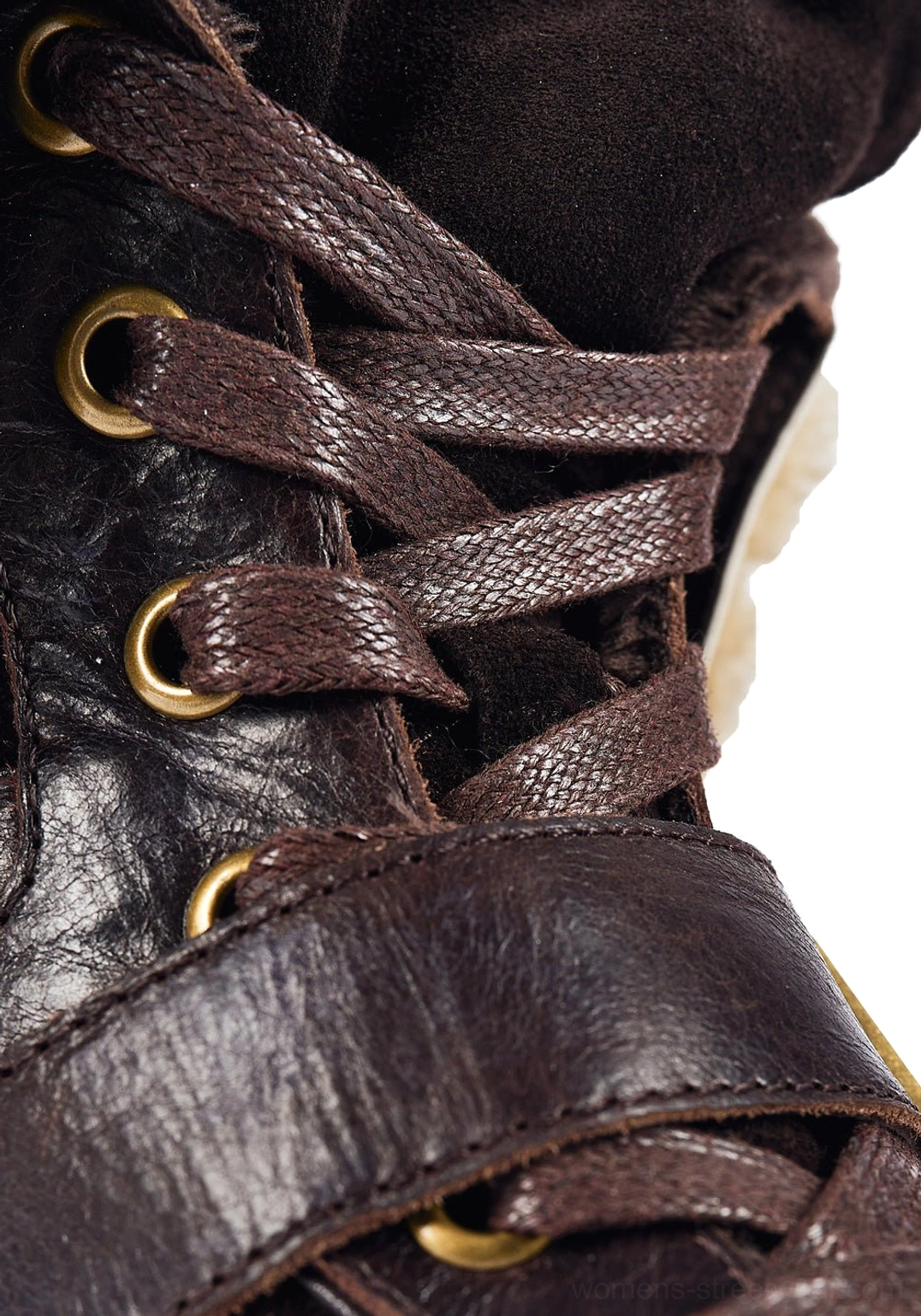 Close-up view of dark brown leather upper with brass eyelets, leather laces, and western buckle strap
