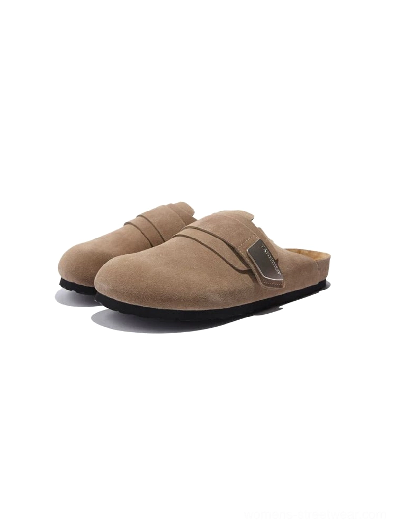 Light tan closed-toe suede leather mule sandals with adjustable buckle strap, contoured footbed, and black rubber foam outsole