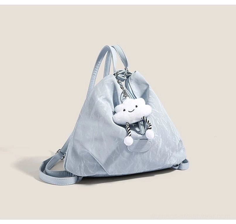 Light blue cloud charm hobo bag shown with detachable crossbody strap and crinkle textured synthetic shell
