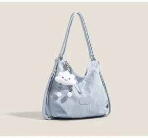 Light blue cloud charm crinkle convertible hobo shoulder bag with silver hardware and plush cloud pendant front three quarter view