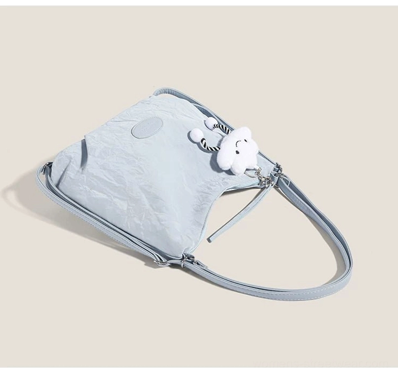 Light blue crinkle hobo shoulder purse with removable crossbody strap and silver hardware side profile