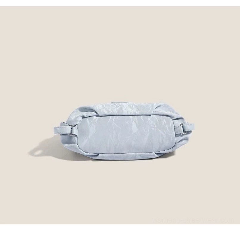 Top rear view of light blue crinkle convertible hobo bag showing compact profile and side expansion zipper details
