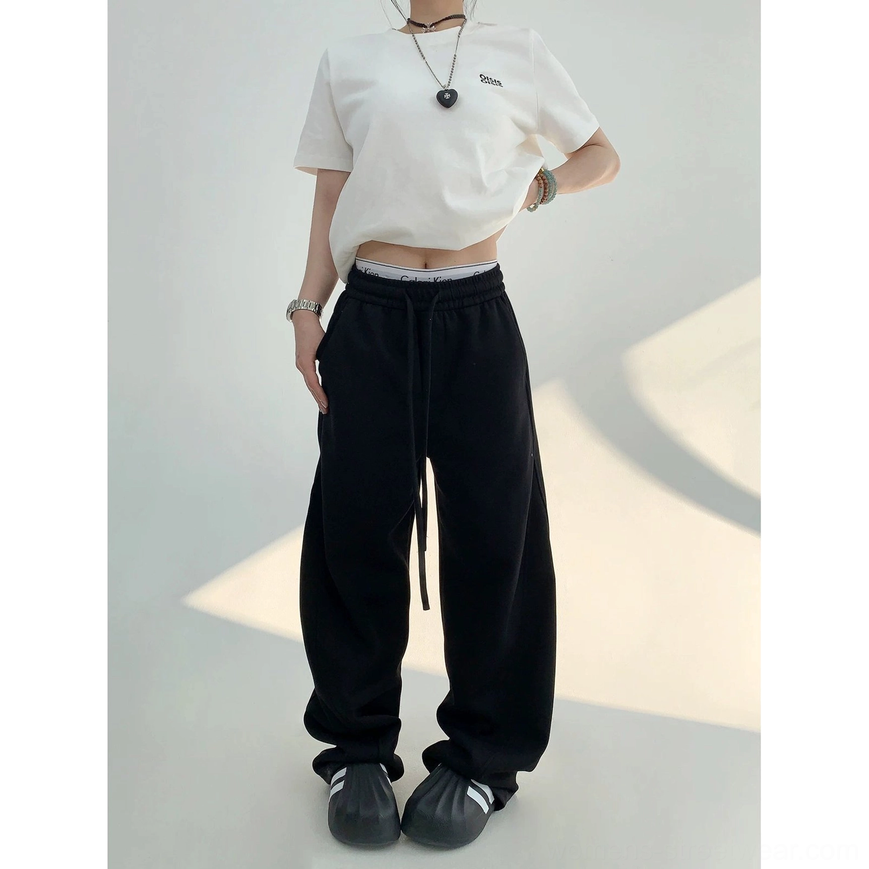 Black cloud soft wide-leg sweatpants in a casual streetwear outfit with a white tee and mini bag