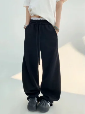 Black cloud soft high-waist wide-leg streetwear sweatpants shown in a low-angle full-body front outfit view