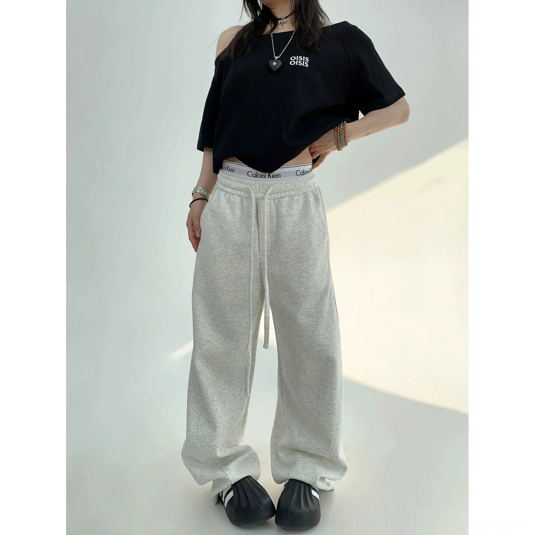 Light gray cotton fleece high-waist wide-leg sweatpants with long drawstrings and a loose straight-leg silhouette