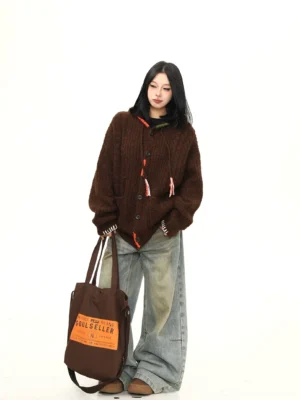 Brown oversized hooded knit cardigan styled with vintage wide leg jeans and canvas tote in full front view