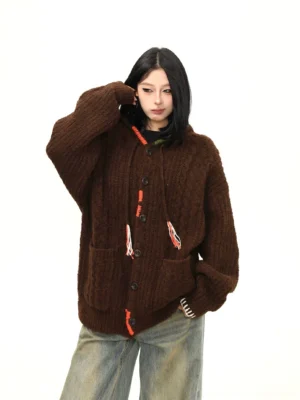 Cocoa brown oversized hooded knit streetwear cardigan front three quarter view with textured knit and contrast drawstrings