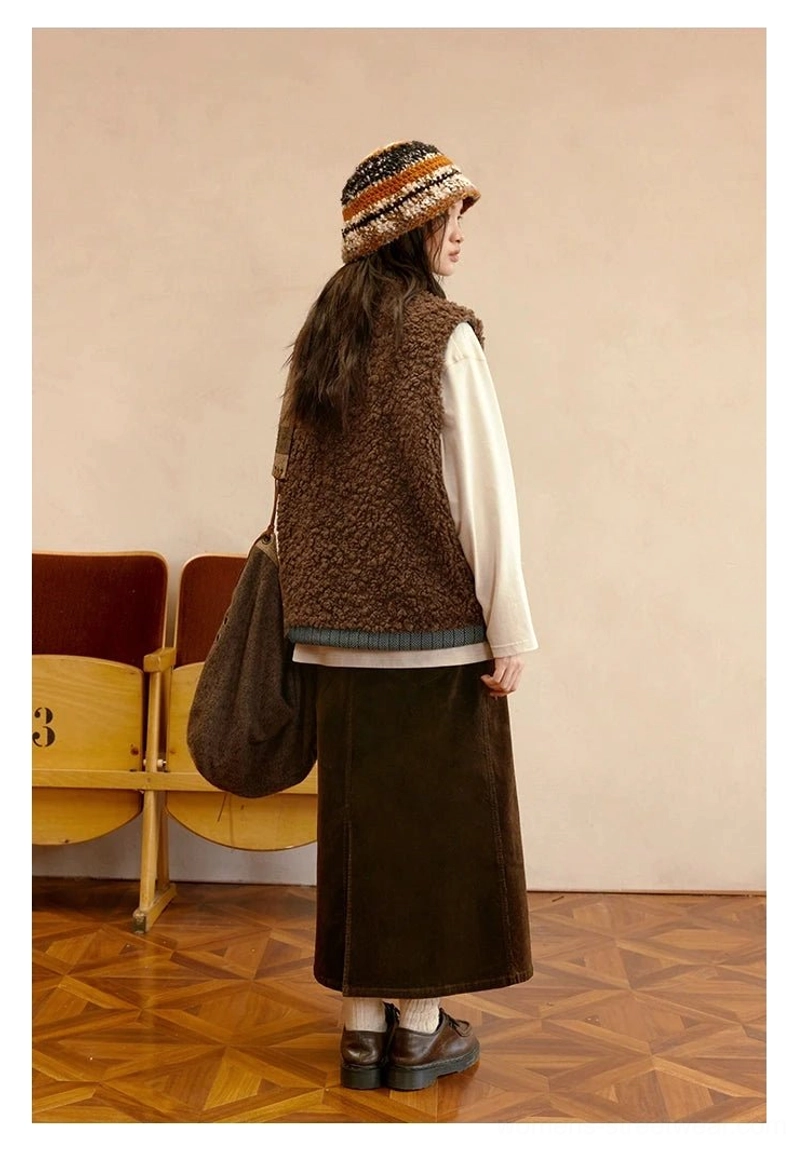 Back view of cocoa brown reversible sherpa vest with clean relaxed silhouette and contrast blue denim-inspired hem trim