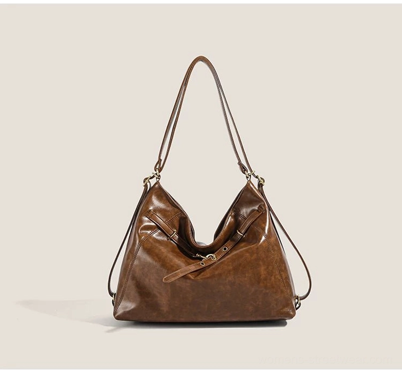 Coffee brown buckle detail hobo shoulder bag with adjustable convertible strap, vintage-inspired front hardware, and spacious everyday streetwear silhouette