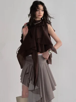 Three-quarter front view of coffee brown cascading ruffle sleeveless top with high waisted gray asymmetric skirt in Seoul-inspired streetwear styling