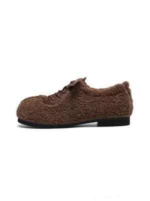 Coffee brown faux shearling split-toe lace-up flats with plush exterior and slim black streetwear outsole shown in side profile