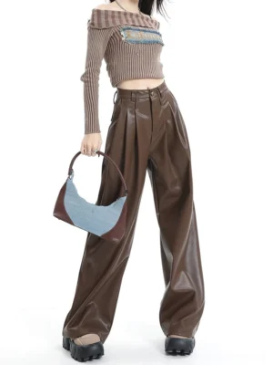 Coffee brown high-waisted wide-leg PU leather streetwear pants styled with a cropped knit top platform shoes and color-block shoulder bag