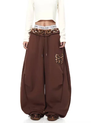 Coffee brown leopard trim wide-leg fleece sweatpants shown from the front with oversized streetwear fit drawstring waist and leopard letter patch