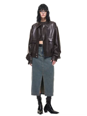 Coffee brown PU leather jacket full body front view with spread collar chest flap pockets and denim midi skirt styling