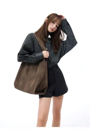 Coffee brown oversized suede-feel hobo shoulder bag shown from the front three-quarter view with a wide strap and relaxed streetwear silhouette