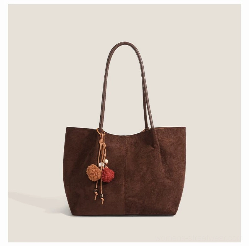 Dark coffee brown suede style tote bag with dual straps and mixed brown and red pom pom pendant for Korean casual fashion