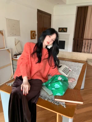 Coffee brown velvet maxi skirt styled with an orange fuzzy knit sweater and white statement earrings in a modern Korean fashion look