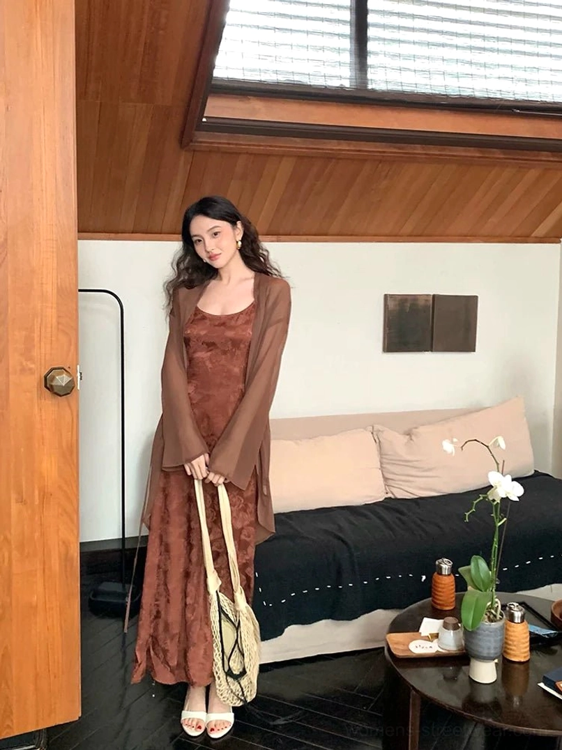 Coffee color floral jacquard satin fishtail slip dress styled with a sheer cardigan in a vintage living room