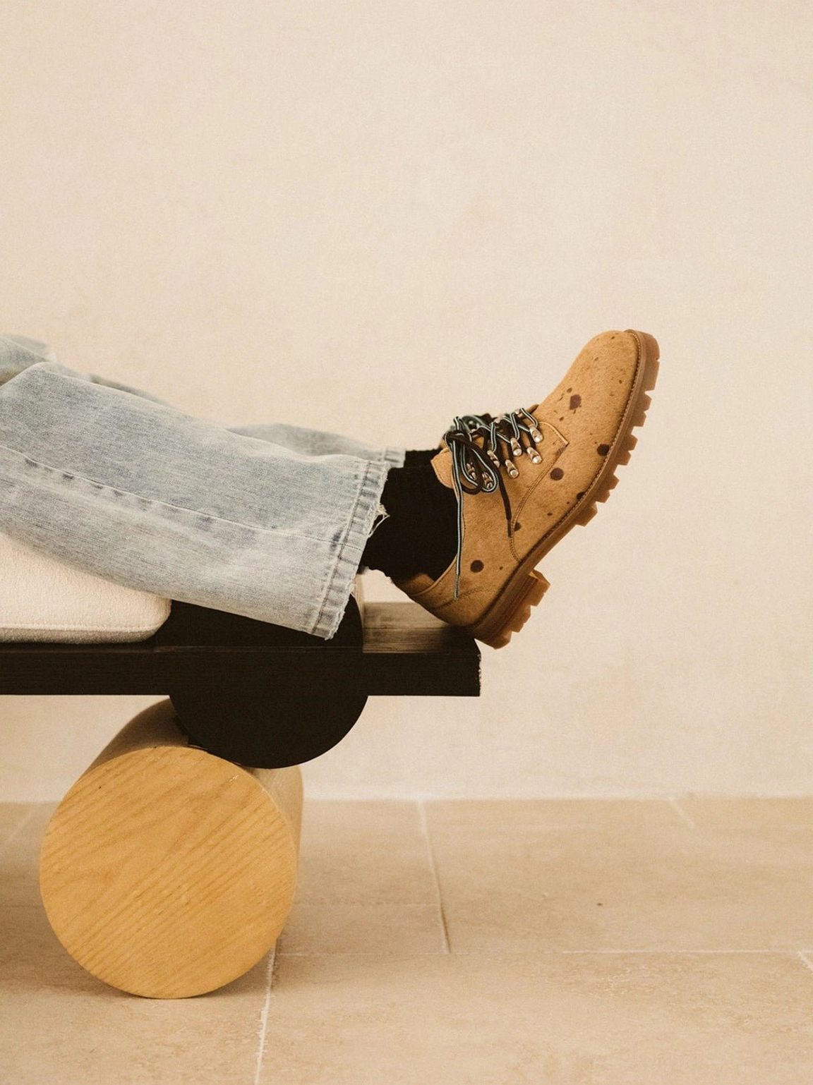 Coffee brown spotted pony hair effect Derby shoes with contrast laces worn with light blue jeans in a modern streetwear outfit