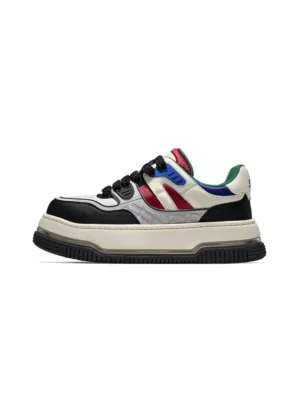 Color-blocked chunky platform streetwear sneaker in off-white with black toe cap and red blue accent stripes on white background