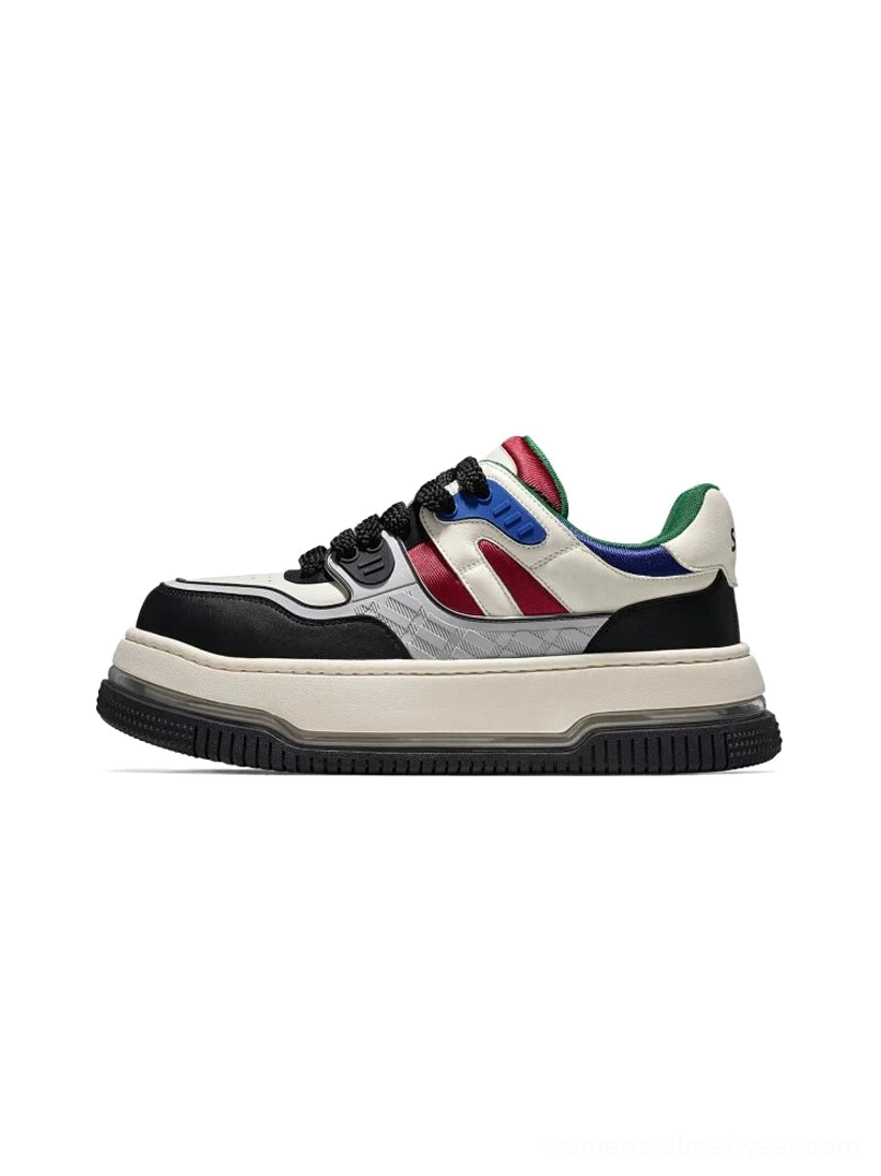 Color-blocked chunky platform streetwear sneaker in off-white with black toe cap and red blue accent stripes on white background