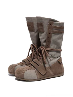 Front view of a pair of color-blocked hybrid boxing boots with rounded toes, textured suede-style and canvas panels, laces, and ankle straps