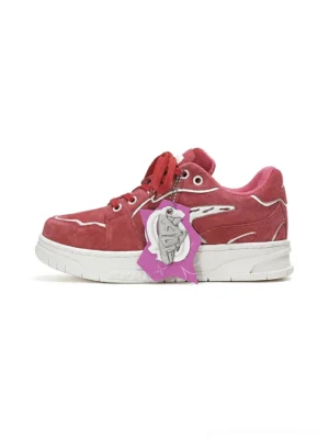 Burgundy suede color-pop low-top skate sneaker shown from a left three-quarter angle with white wing-shaped side detailing and thick white rubber outsole