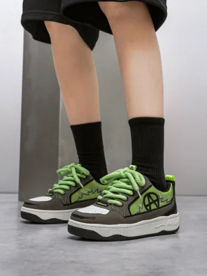 On-foot green colorblock graphic skate sneakers styled with black crew socks and black shorts