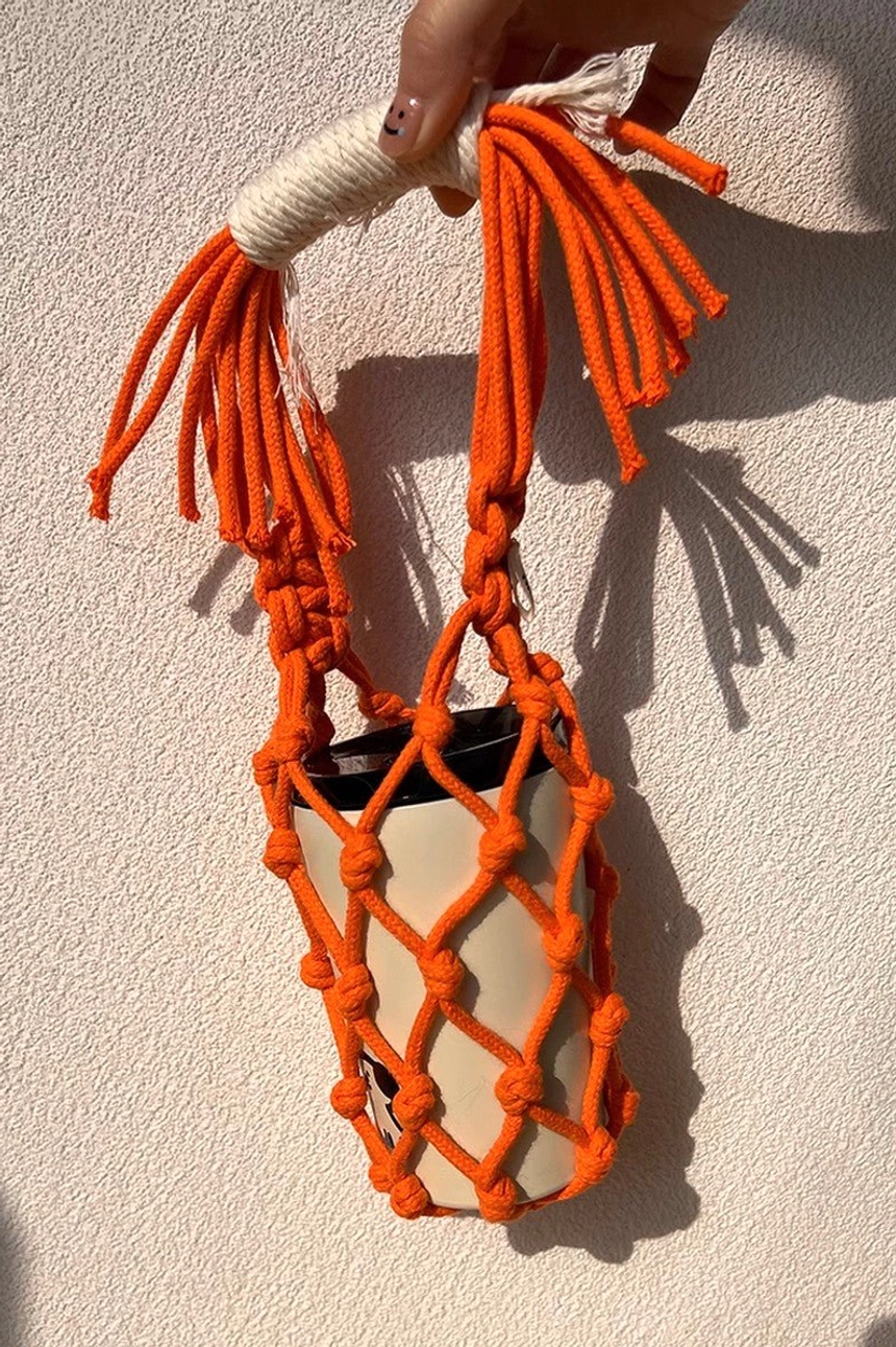 Colorful cotton macrame water bottle carrier product view with woven net pocket, tassel details, and compact hands-free design