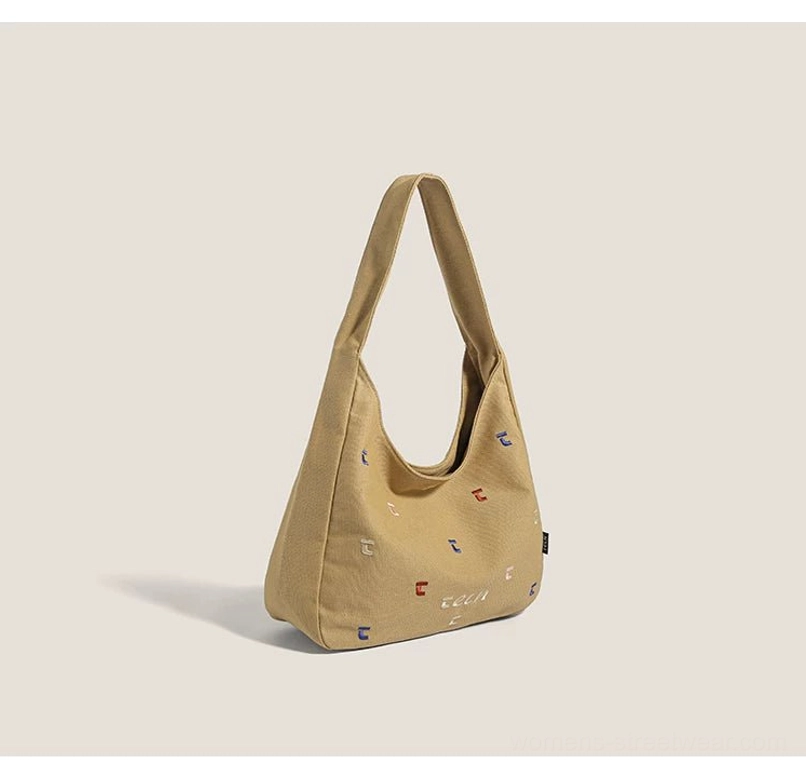 Brown confetti embroidered canvas hobo shoulder bag in a front three quarter studio product view