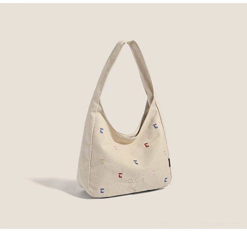 Khaki confetti embroidered canvas hobo shoulder bag in a front three quarter studio view