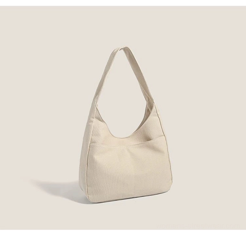Off white plain canvas hobo shoulder bag back view with minimalist exterior slip pocket