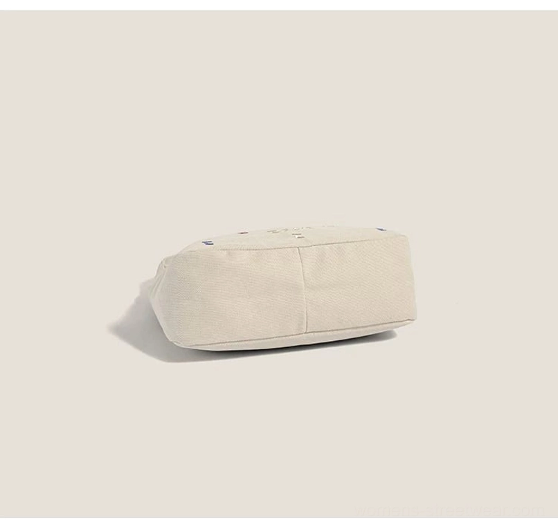 Off white minimalist canvas hobo bag bottom view showing the flat rectangular base