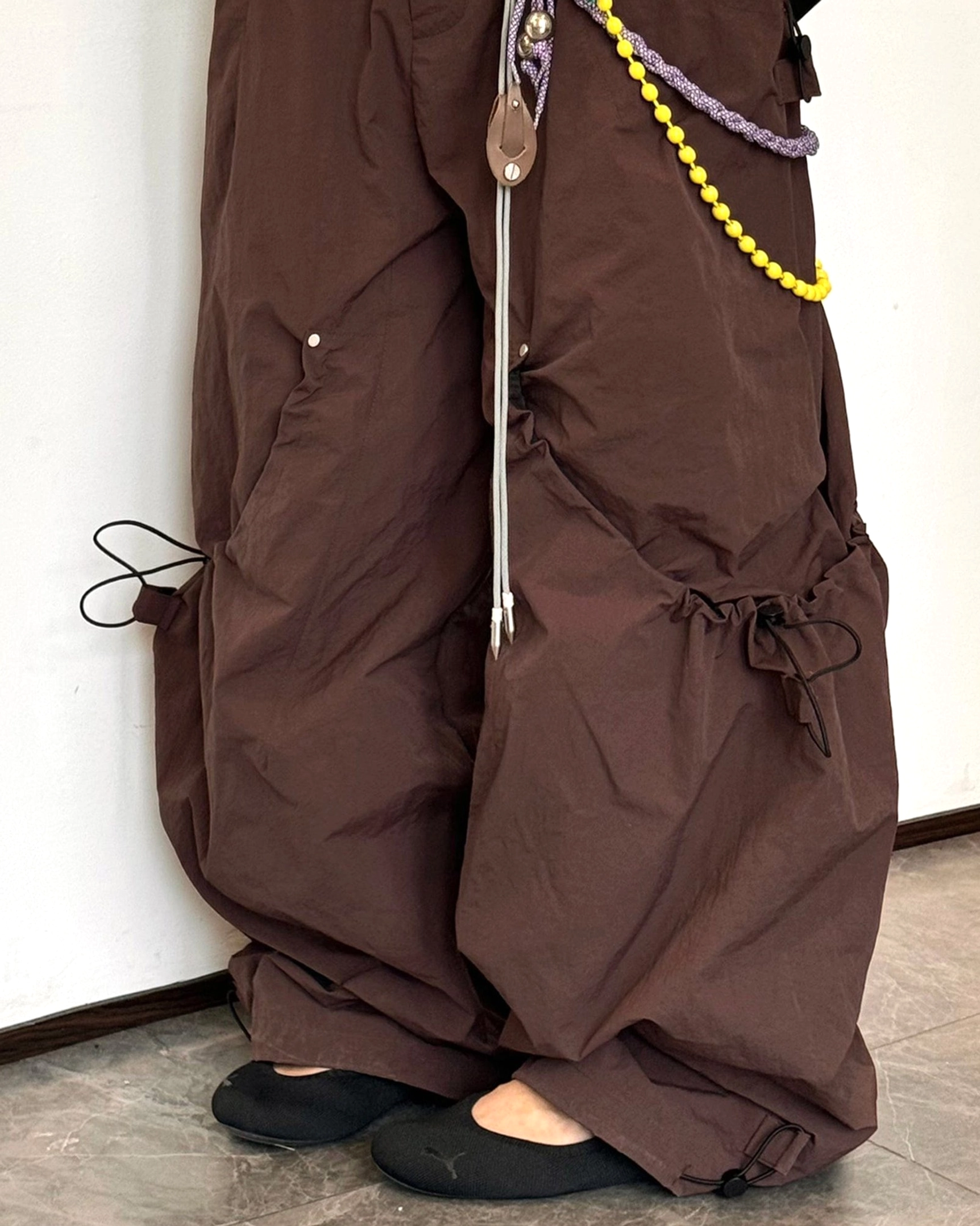 Contemporary wide leg cargo pants with adjustable drawstring details and oversized silhouette for Korean street style