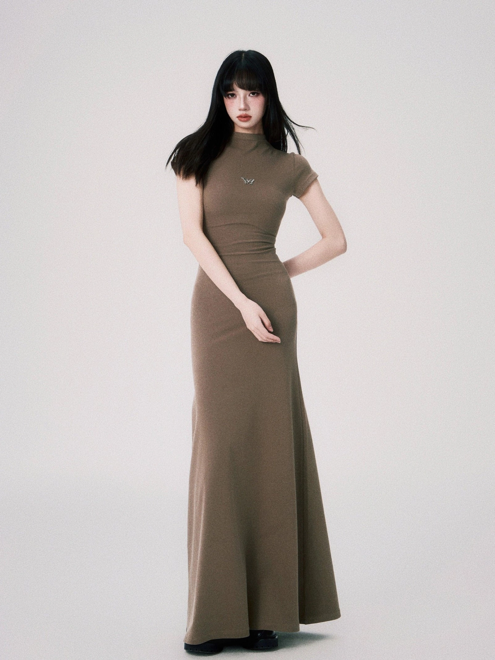 Contemporary women’s bodycon maxi dress featuring a small butterfly ornament and elegant ankle length cut