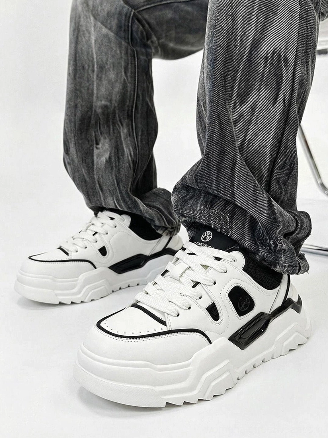 Contrast cutout platform sneakers styled with dark baggy denim in a streetwear outfit